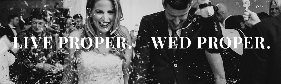 Black and white photo bride and groom leaving wedding with confetti and custom tailored commonwealth proper tuxedo and black tie