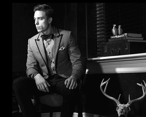 Photo of a man in a suit sitting at a table